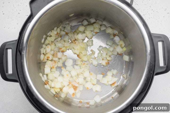 Effortless Instant Pot White Chicken Chili 6 Diced onion and minced garlic in the bottom of an Instant Pot.