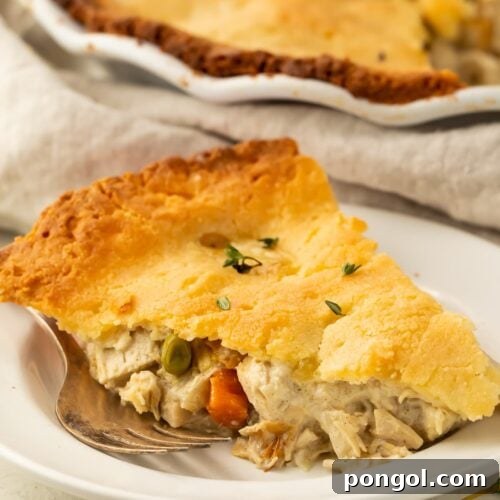 A slice of keto chicken pot pie on a plate, showing the rich filling and golden crust.
