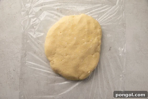 Keto Comfort Chicken Pot Pie 7 Keto pie dough formed into a flattened disc on plastic wrap, ready for chilling.