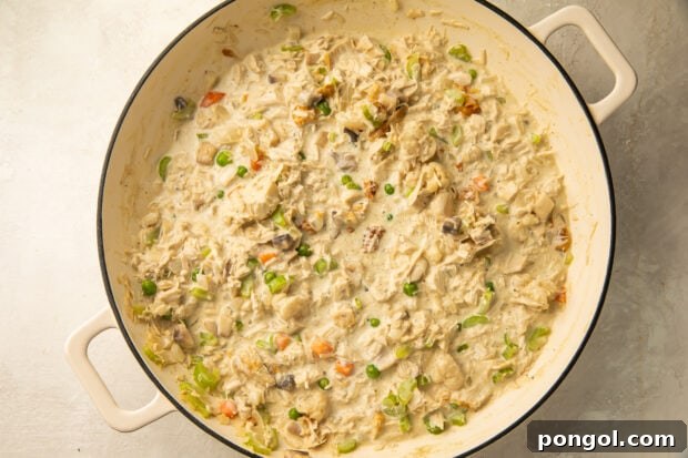 Keto Comfort Chicken Pot Pie 9 Keto chicken pot pie filling simmering in a large saucepan, looking creamy and rich.