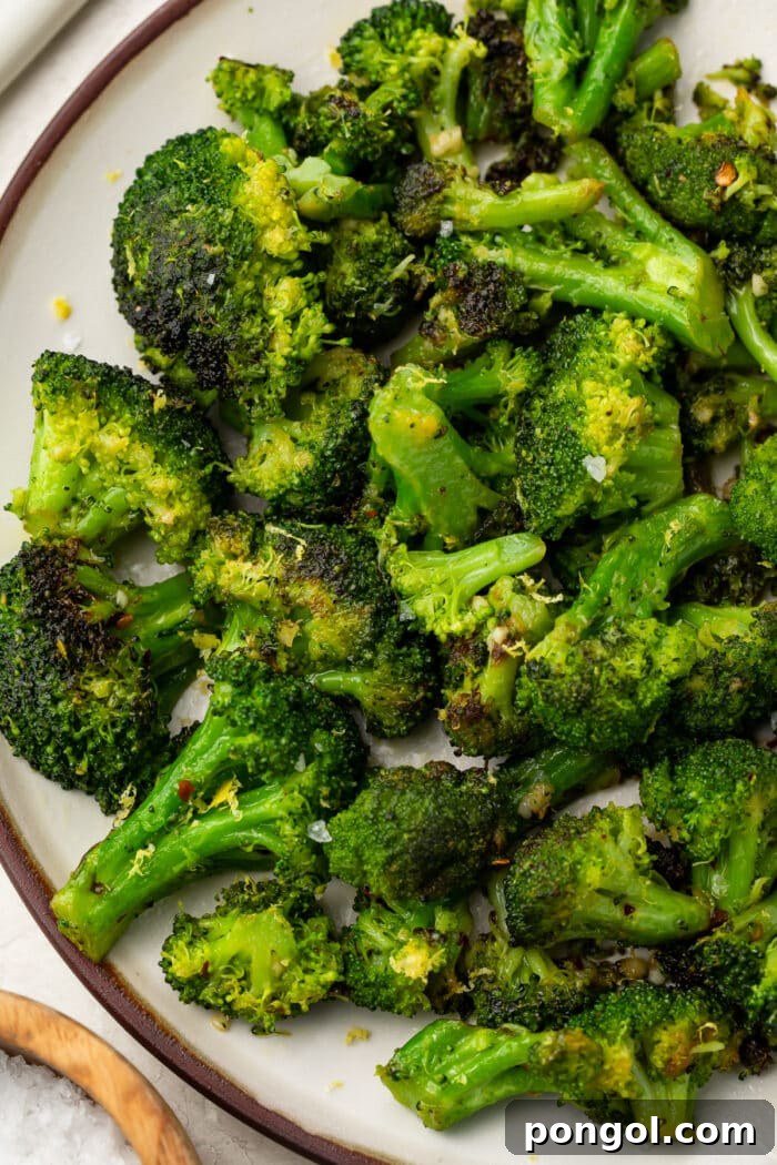 Sautéed Broccoli Florets 3 Close-up of Sauteed broccoli on a white plate, showing the tender-crisp texture