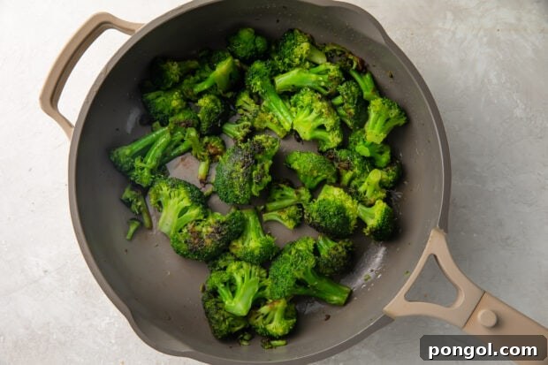 Sautéed Broccoli Florets 6 Sauteed broccoli in a large grey skillet with water