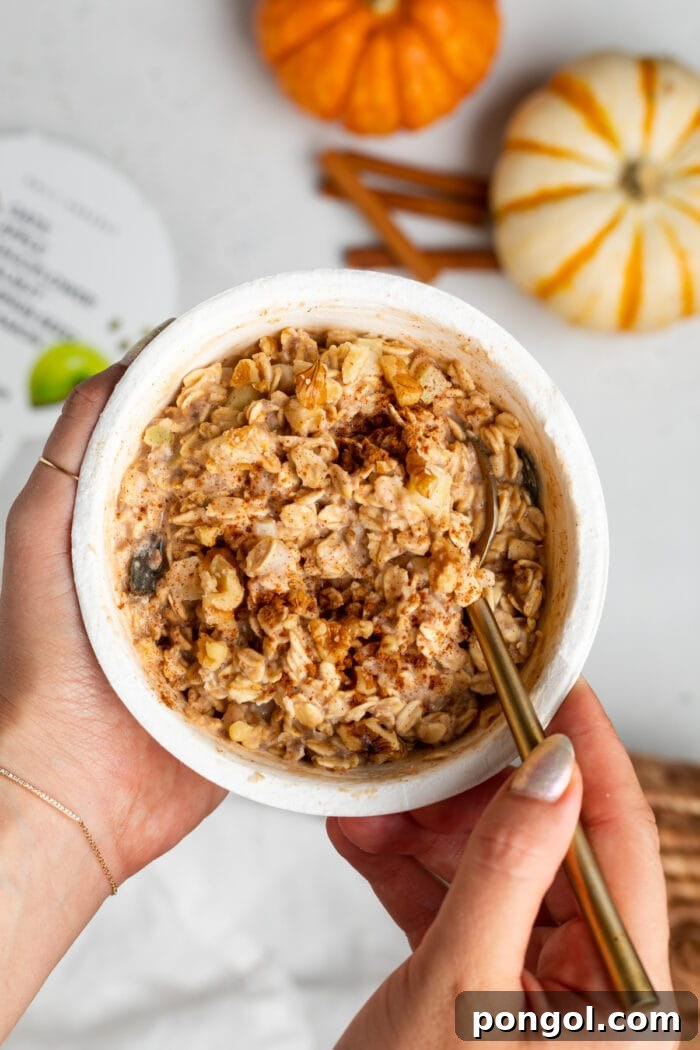 Daily Harvest: Embracing Autumn with Organic Eats 5 Two hands holding an oat bowl with spoon