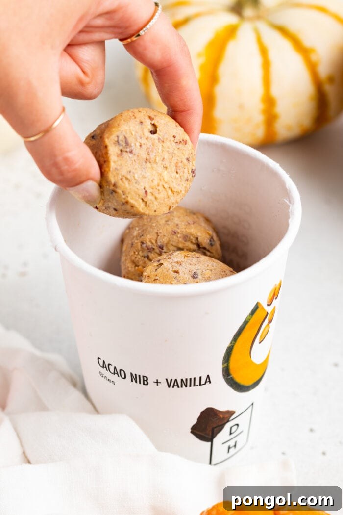 Daily Harvest: Embracing Autumn with Organic Eats 9 Daily Harvest bites in a paper cup. A hand picks up one bite out of the cup