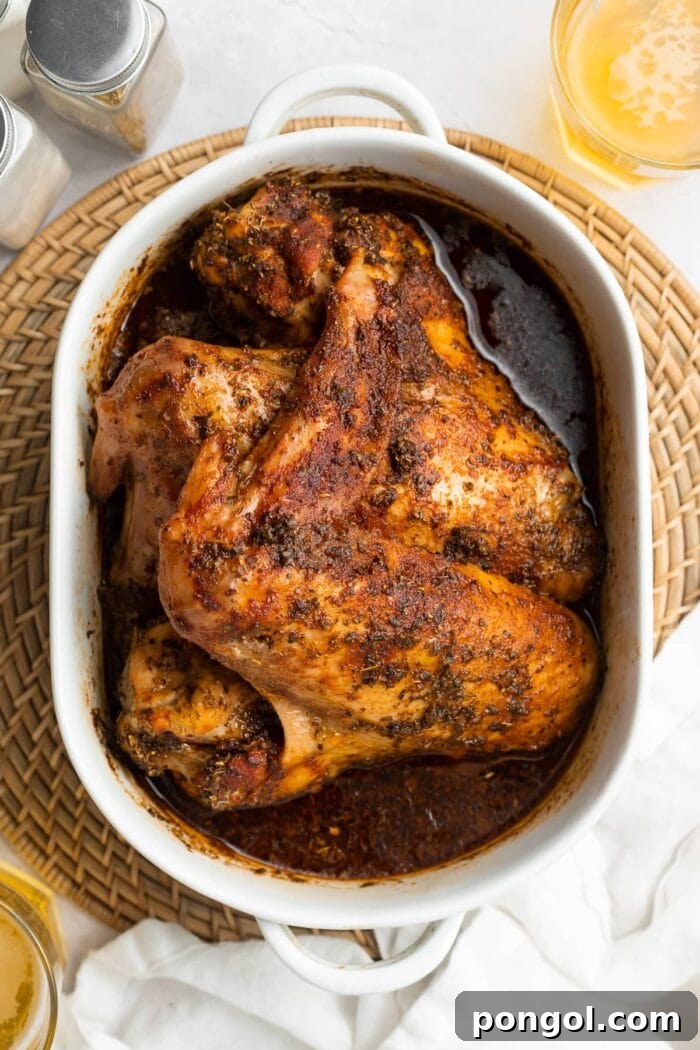 overhead image of baked turkey wings in a baking dish with beer on the side