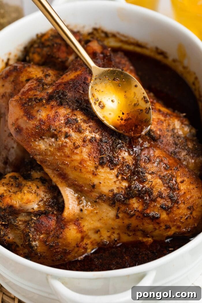pan drippings being poured over baked turkey wings
