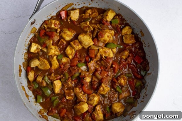 Chicken jalfrezi simmering in a large skillet