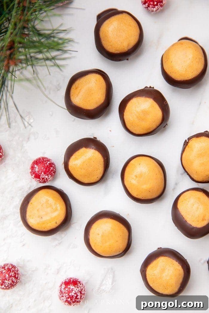 Keto buckeyes, half-dipped in rich chocolate, arranged artfully on a serving dish.