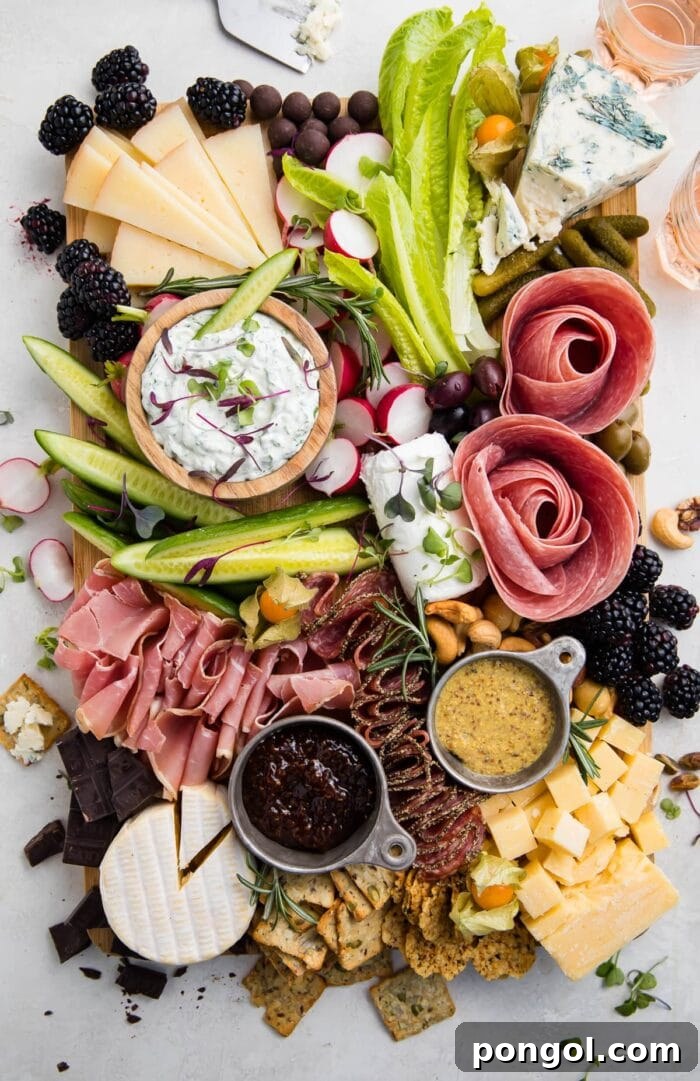 Overhead view of a vibrant keto charcuterie board filled with various cheeses, cured meats, nuts, olives, and low-carb crackers.
