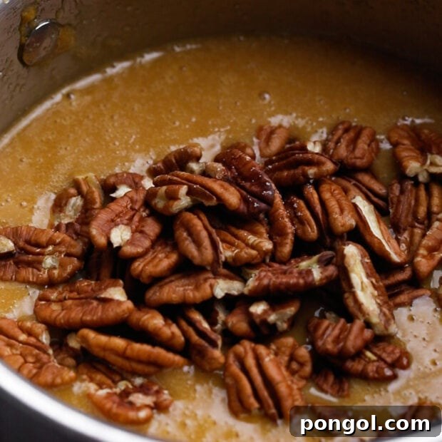 Decadent Keto Pecan Pie 8 Adding eggs and vanilla to cooled keto pecan pie filling