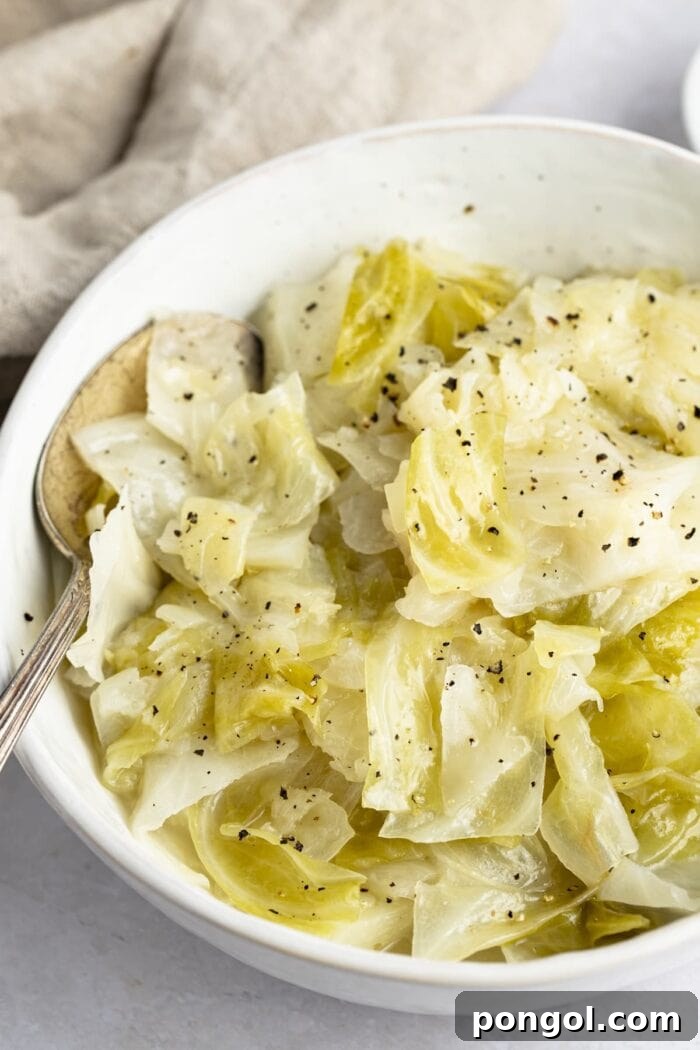 Instant Pot cabbage in a white bowl with a neutral napkin in the background