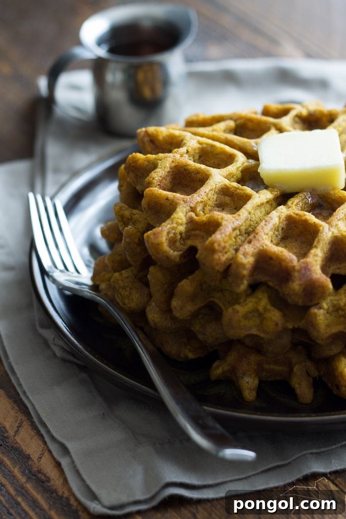 Vegan pumpkin waffle batter being poured onto a waffle iron