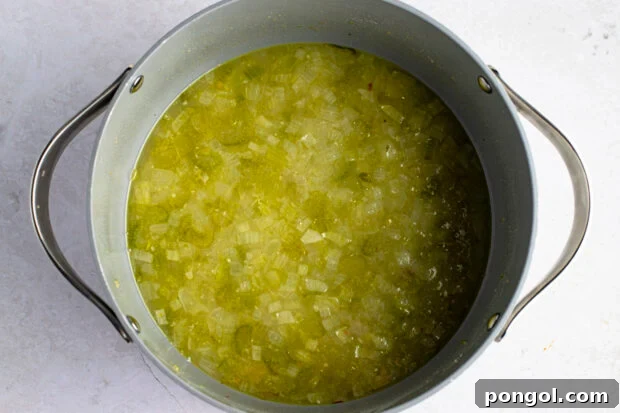 Chicken broth and celery in large pot