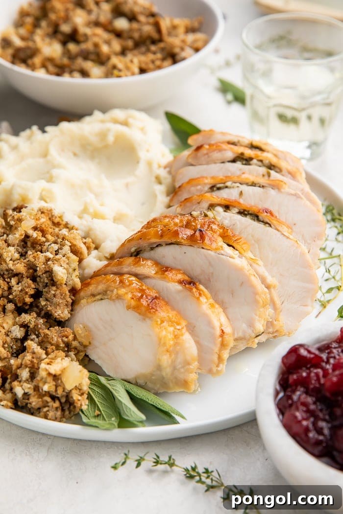 Instant Pot turkey breast slices on a plate with dressing and mashed potatoes