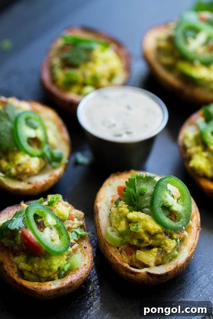 Close-up of vegan guacamole potato skins, highlighting the fresh and creamy topping.