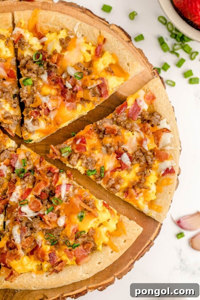 Overhead shot of breakfast pizza cut into slices on a wooden pizza board