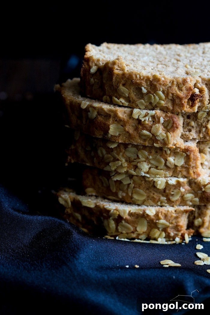 Sliced whole wheat beer bread on a wooden board, ready to serve