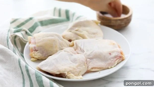 Season chicken thighs liberally with salt.