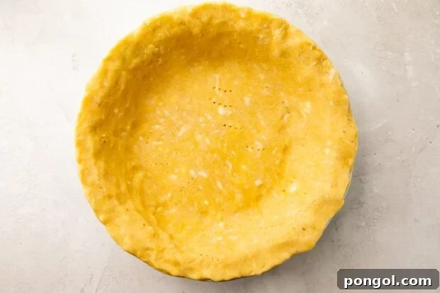 Perfectly Flaky Keto Gluten-Free Low-Carb Pie Crust 8 Baked keto pie crust in pie plate, showing a golden brown finish.