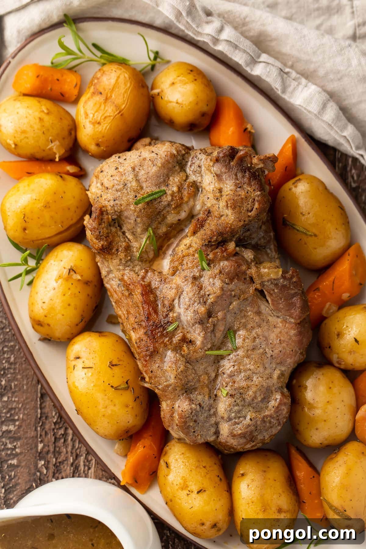 Instant Pot pork roast with carrots and potatoes on a large oval-shaped dish