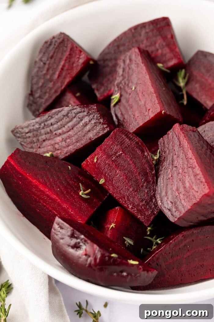 Perfectly cooked Instant Pot beets in a large white serving bowl