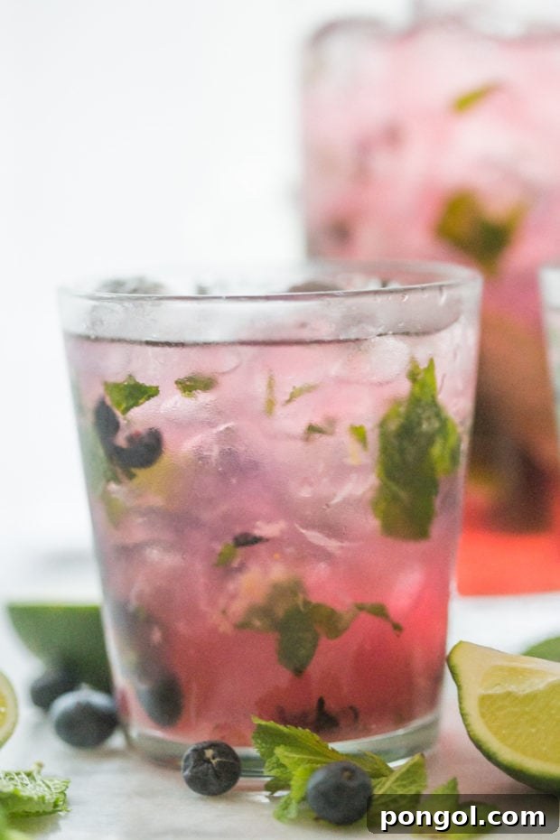 Party-Perfect Blueberry Mojitos 3 Blueberry Mojitos for a Crowd - perfectly light, minty, fruity and easy // 40 Aprons