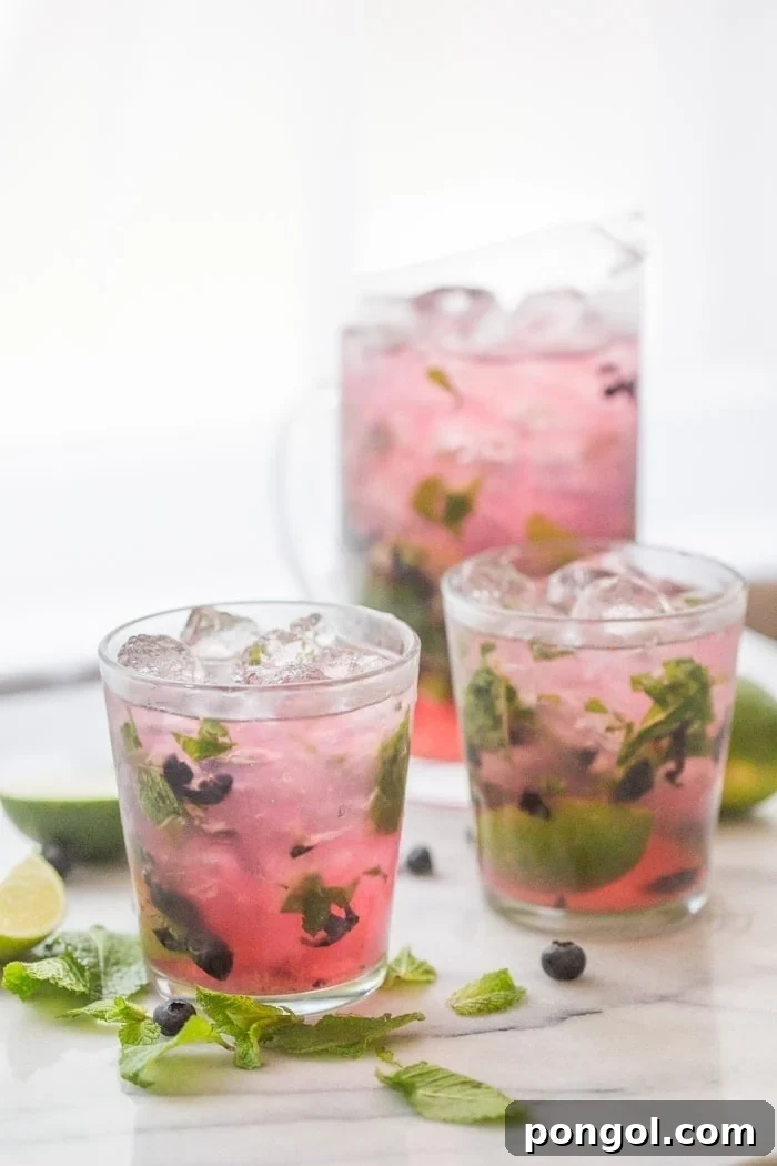 Party-Perfect Blueberry Mojitos 6 Blueberry Mojitos for a Crowd - perfectly light, minty, fruity and easy // 40 Aprons