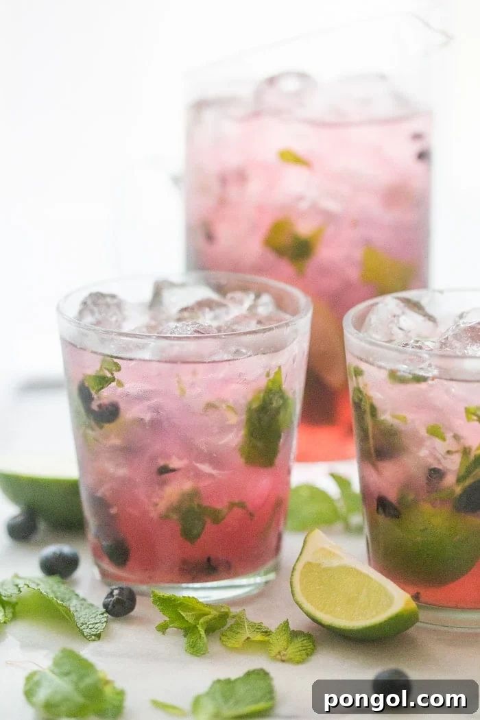 Party-Perfect Blueberry Mojitos 8 Blueberry Mojitos for a Crowd - perfectly light, minty, fruity and easy // 40 Aprons