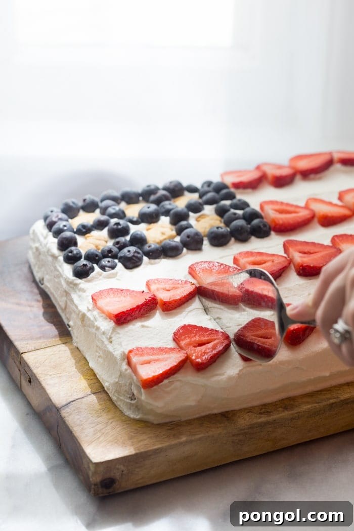 Top view of patriotic flag cake decorated with fresh berries and Annie's Bunny Grahams