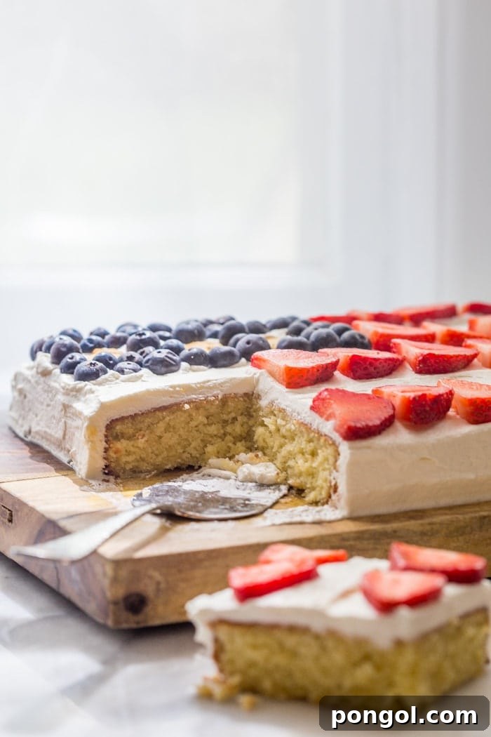 Side view of the flag cake showing layers of yellow cake and cream frosting