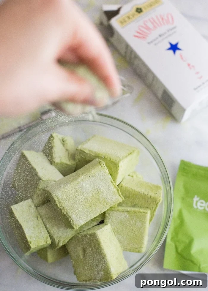Hand-cut Matcha Marshmallows dusted with rice flour, showcasing their soft interior.