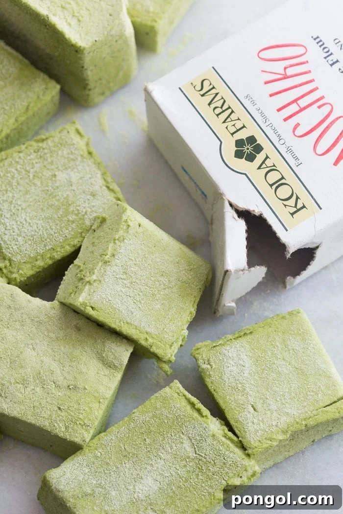 Matcha Marshmallows artfully arranged on a cutting board, ready for a taste.