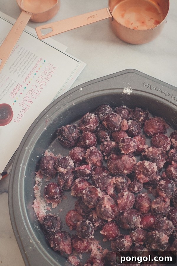 A close-up of a spoon digging into the creamy goat cheese and roasted cherry ice cream.
