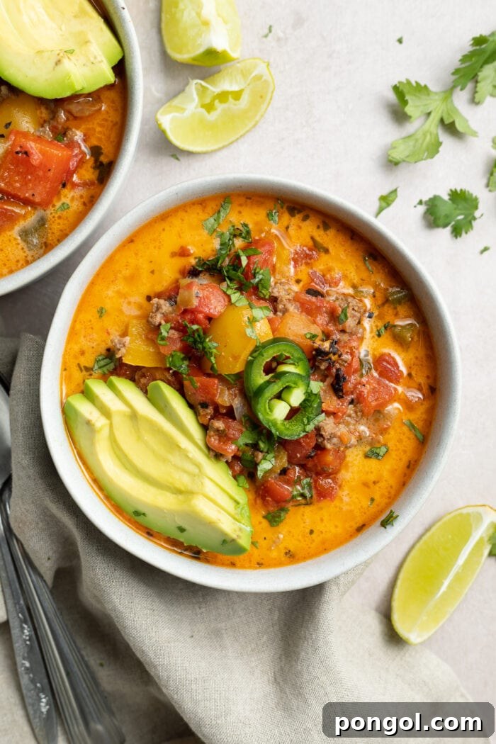 Paleo Creamy Taco Delight 2 overhead image of whole30 creamy taco soup with sliced avocado and jalapenos on top
