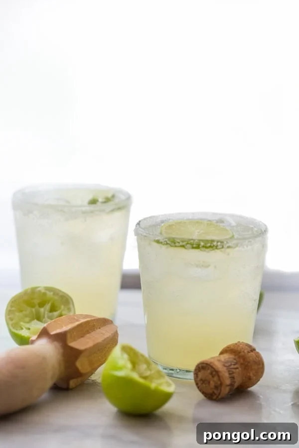 A collection of ingredients for the Champagne Margarita, including tequila, lime, and orange liqueur.