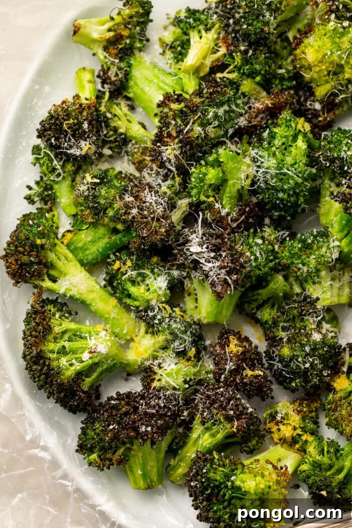 Overhead, closeup view of air fryer broccoli on a white plate