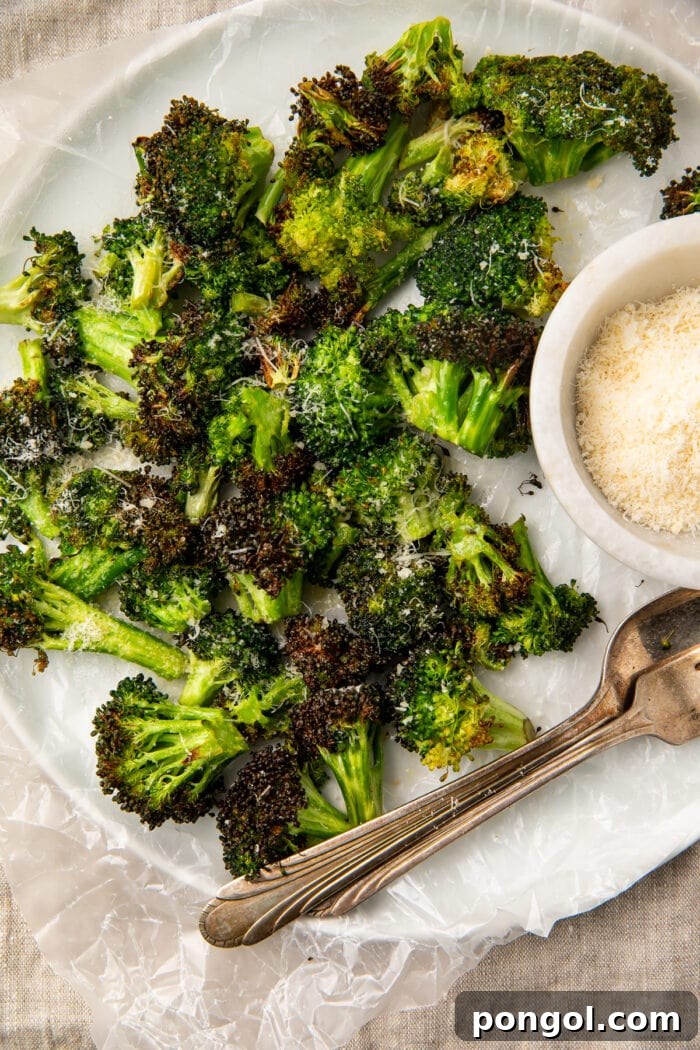 Overhead view of air fryer broccoli on a plate with dipping sauce