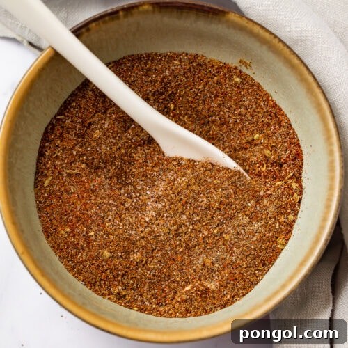Keto taco seasoning in a bowl with a white spoon
