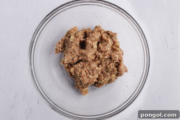 Meatball mixture in large glass bowl