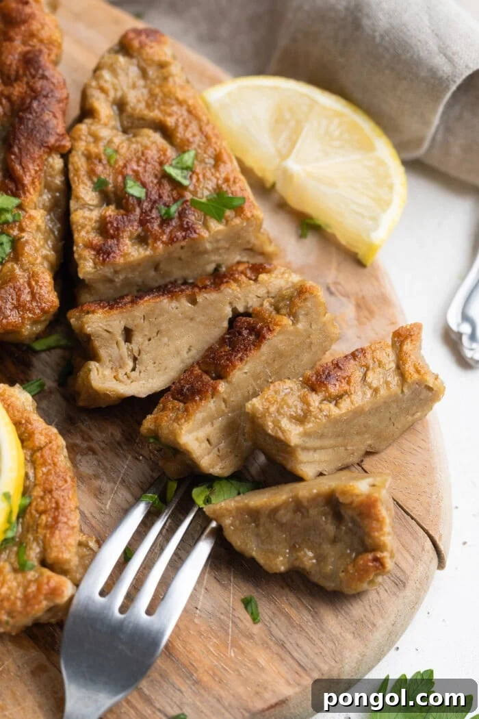 Vegan Seitan Chick'n 2 seitan chicken sliced on a cutting board with fresh parsley on top