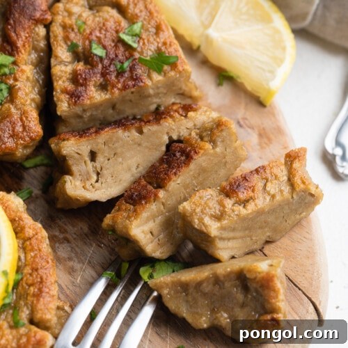 seitan chicken sliced on a cutting board with fresh parsley on top
