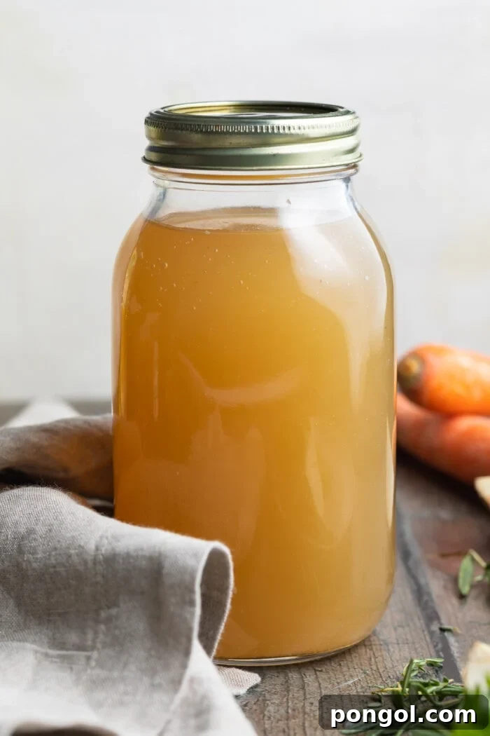 Golden Elixir: Slow Cooker Bone Broth 2 Large jar of homemade crockpot bone broth on a rustic wooden table, garnished with fresh herbs, showcasing its rich, amber color and inviting texture.