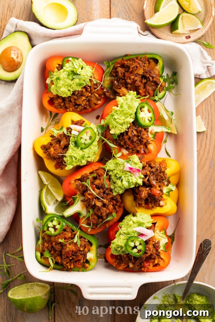 Whole30 Paleo Low Carb Taco Stuffed Peppers 2 Overhead view of Whole30 taco stuffed peppers in a baking dish, showcasing the vibrant colors and hearty filling.