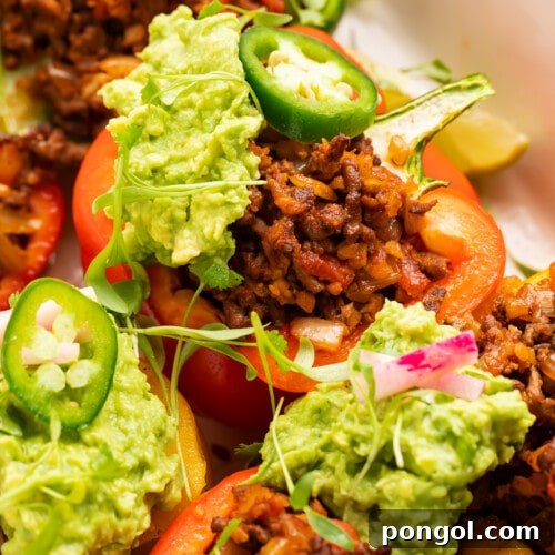 Close-up view of Whole30 taco stuffed peppers in a baking dish, highlighting the savory filling and tender peppers.