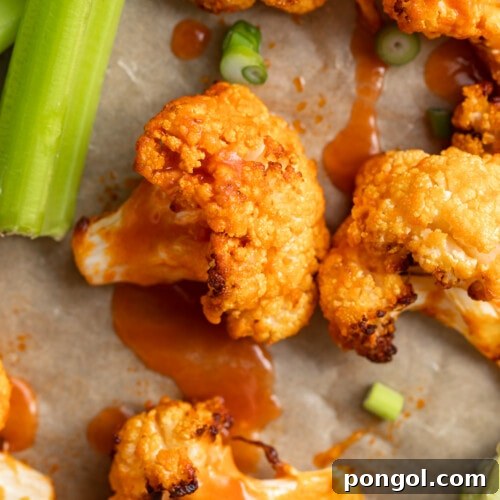 close up image of air fryer buffalo cauliflower with celery on the side