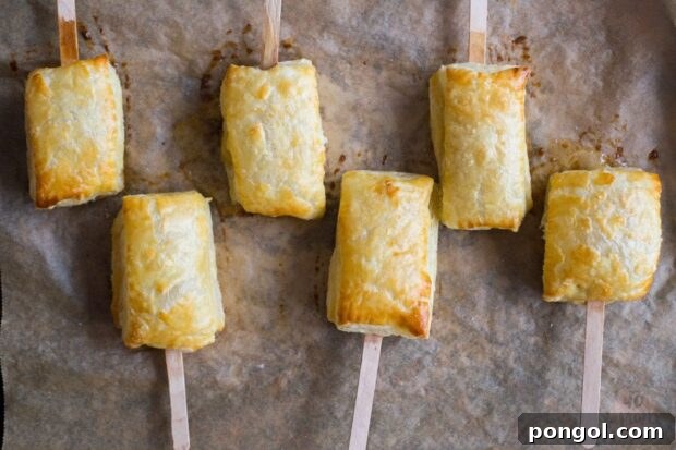 Single baked brie bite with apricot jam, ready to be served as an elegant and easy appetizer.