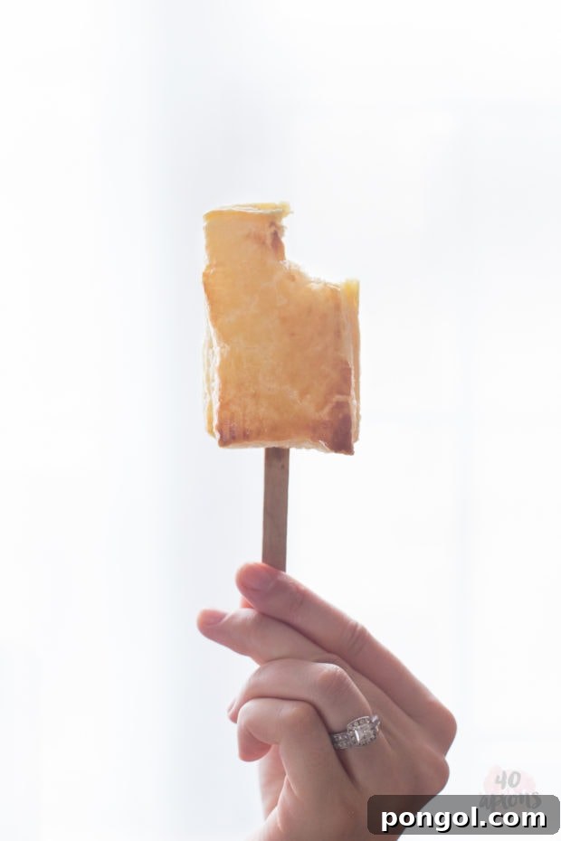 Three baked brie bites with apricot jam, perfectly golden and ready for a festive occasion.