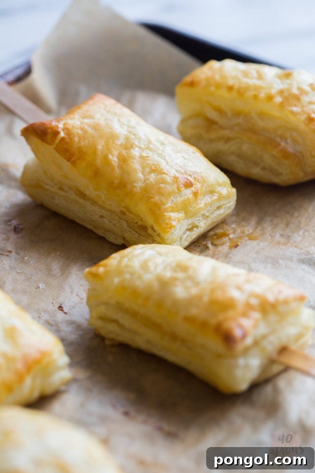 Stacked baked brie bites with apricot jam, showcasing their perfect size for individual servings.