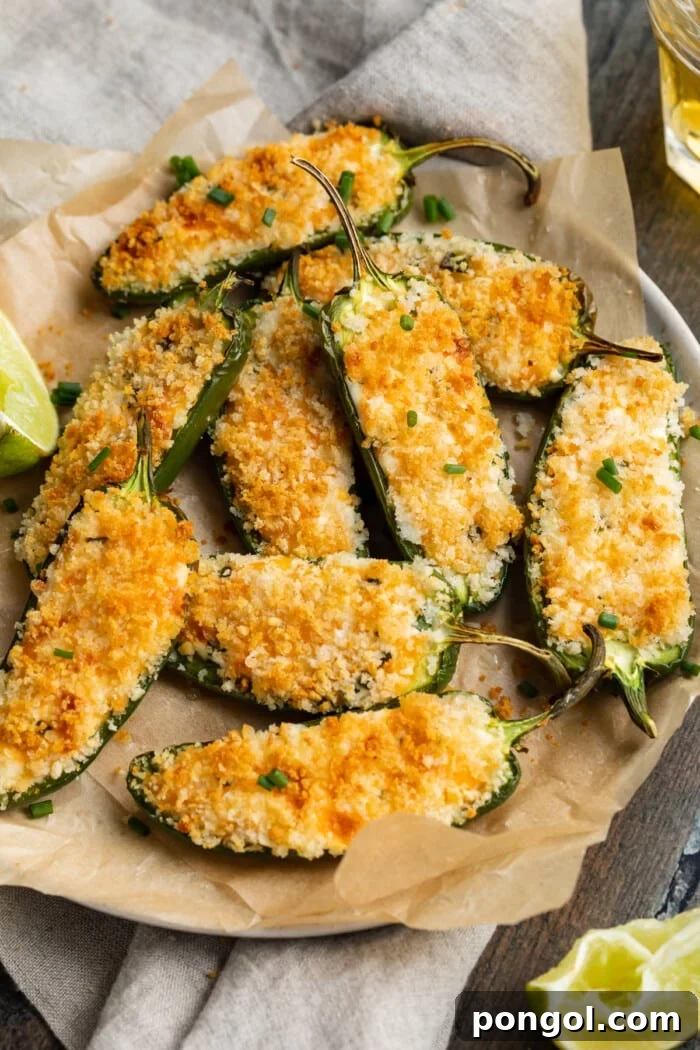 air fryer jalapeño poppers on a plate with limes and beer on the side