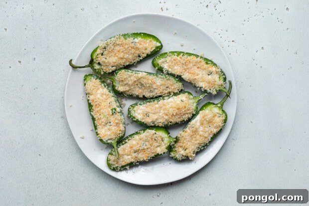 filling jalapeños and dipping in breadcrumbs